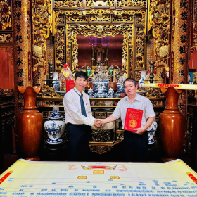 Two men shaking hands in front of a gold ornate room AI-generated content may be incorrect.